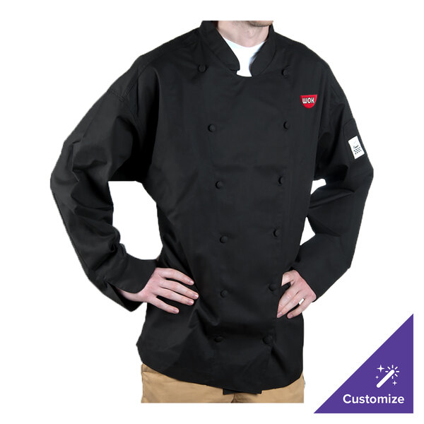 A man wearing a black Chef Revival long sleeve chef coat with his hands on his hips.