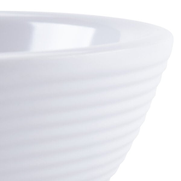 A close-up of a Tablecraft white round ribbed melamine ramekin.