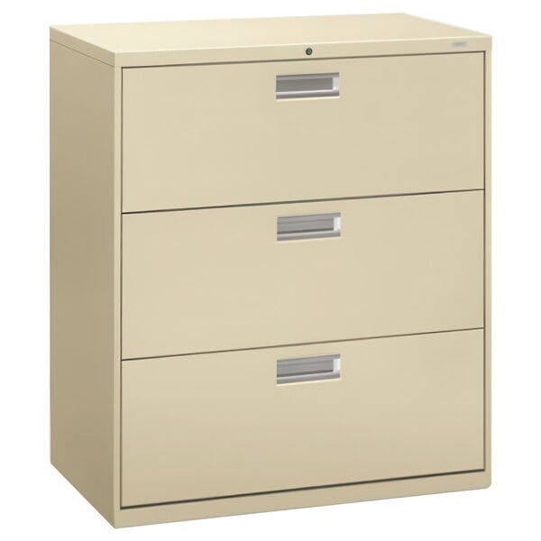 A tan HON Brigade three-drawer lateral filing cabinet.