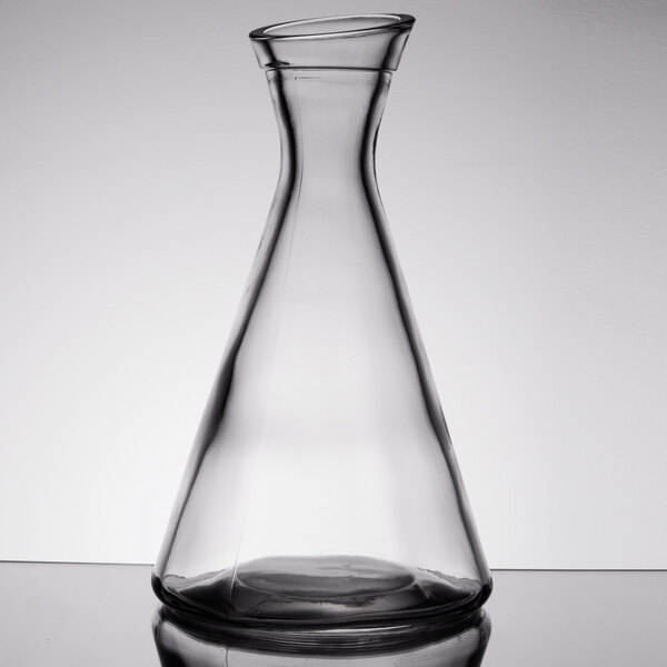 a clear glass beaker with a white cap
