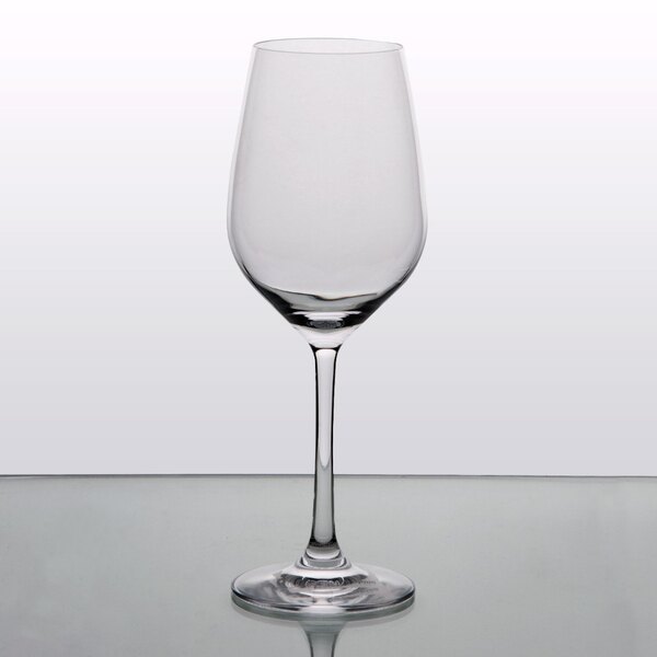 A clear Stolzle white wine glass on a table.