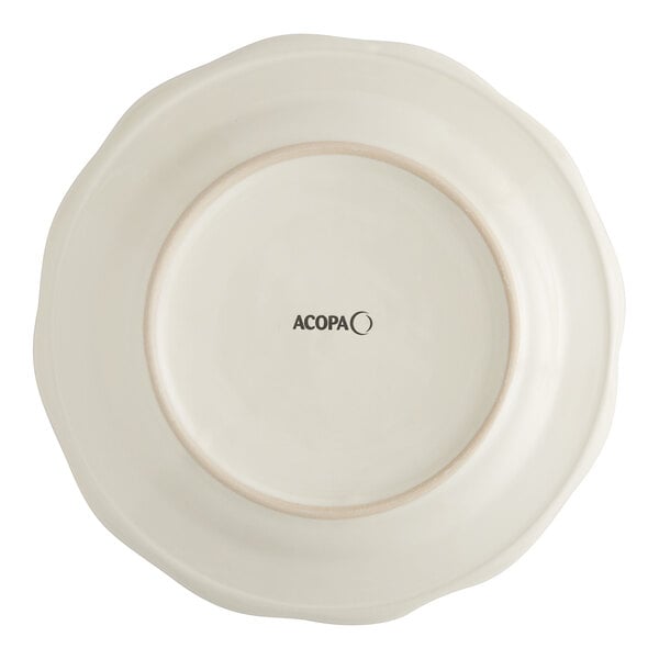 An ivory stoneware plate with black scalloped text that reads "Acopa"