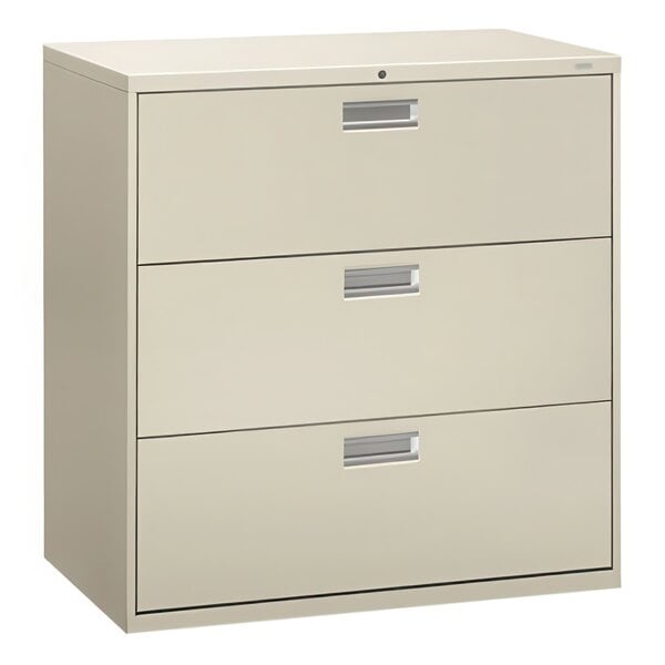 A light gray HON lateral filing cabinet with three drawers and silver handles.