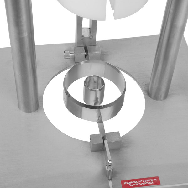 A Tellier metal pineapple corer and peeler with a metal spiral.