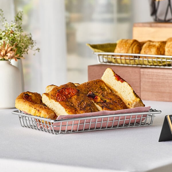 A loaf of bread in a Clipper Mill stainless steel wire grid basket.