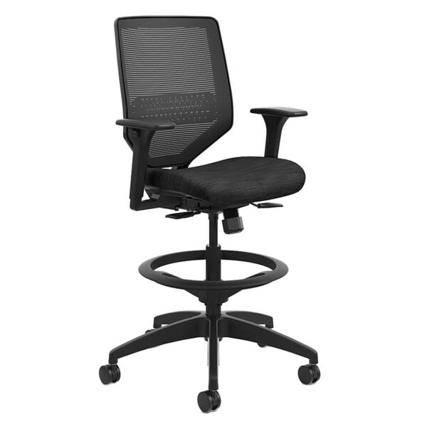 A black HON Solve Series office stool with black mesh back and padded seat and armrests.