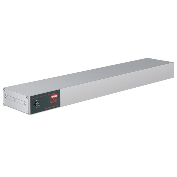 A rectangular metal box with a black label and red light.