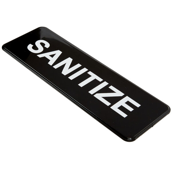 A black and white Vollrath Traex sign that says "Sanitize"