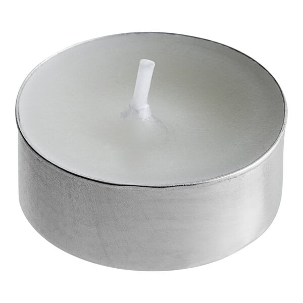 A Leola white wax tea light candle with a white wick in a silver metal holder.