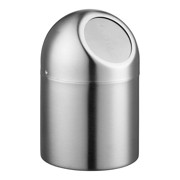 A Clipper Mill stainless steel round tabletop trash can with a flap lid.
