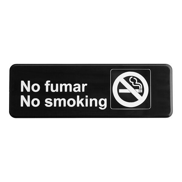 A black and white sign with the words "No Fumar No Smoking"