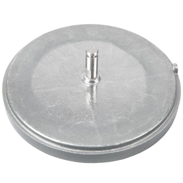 A silver metal grid with a round hole and a metal stick.