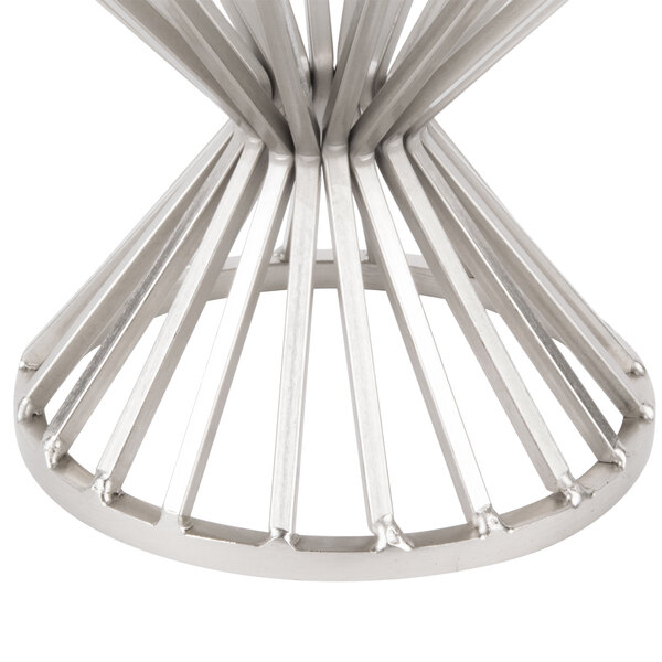 A Clipper Mill chrome plated iron round wire basket with a base on a table.