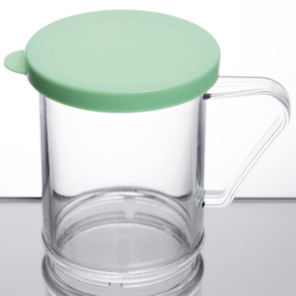 A clear Cambro polycarbonate shaker with a green lid.