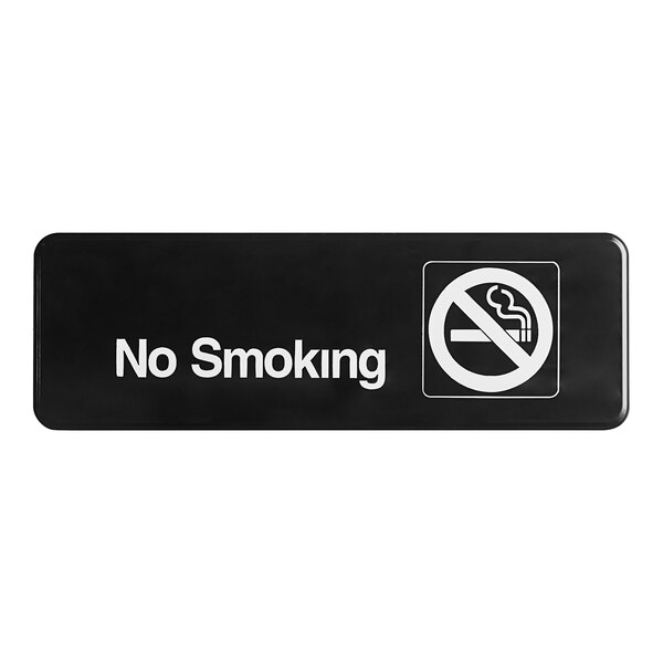 A black rectangular Vollrath No Smoking sign with white text.