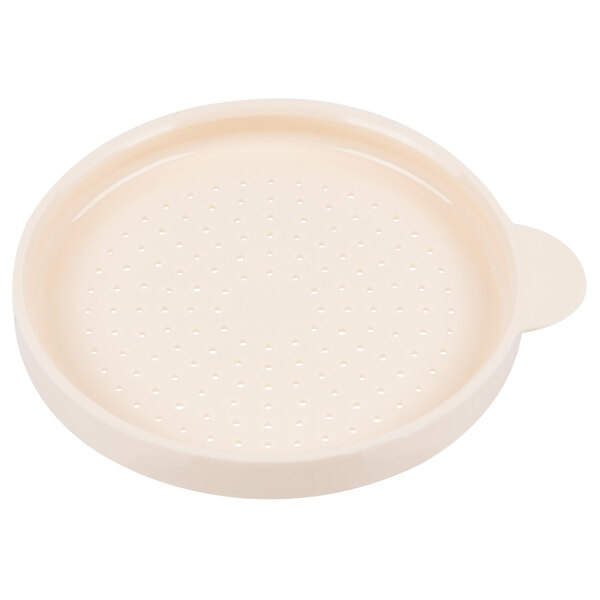 A white round plastic lid with holes.