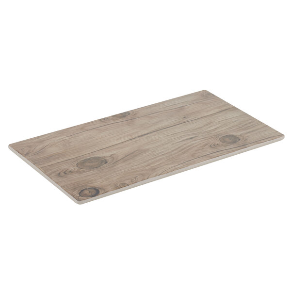A Thunder Group Sequoia faux wood melamine serving board with knots on a table.