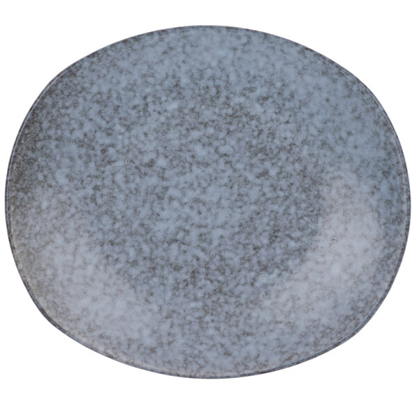 A close-up of a blue rectangular stoneware salad plate with a speckled design.