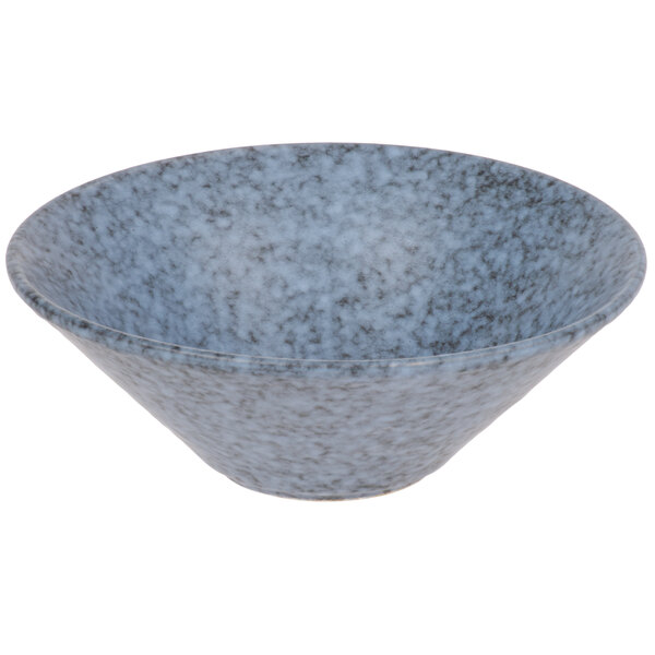 A close-up of a blue Biseki stoneware coupe bowl with a speckled surface.