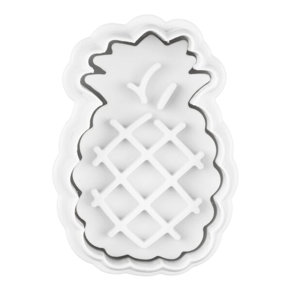 A white plastic cutter in the shape of a pineapple with raised detailing for texture.