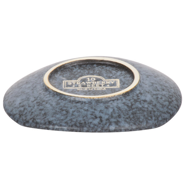 A close-up of a rectangular blue stoneware bread and butter plate with a stone-like texture.