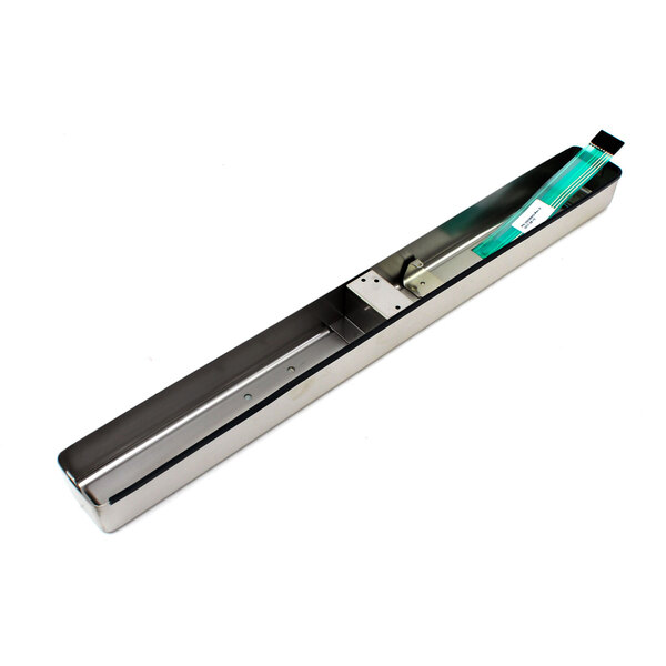 A long rectangular metal object with a green label.