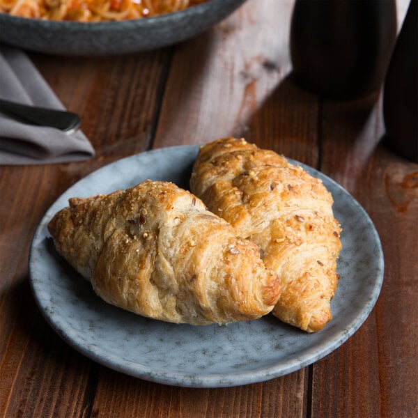 A 10 Strawberry Street Biseki round stoneware bread and butter plate with croissants on it.