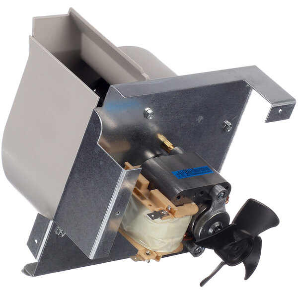 The metal housing of an Amana blower motor with a small propeller inside.
