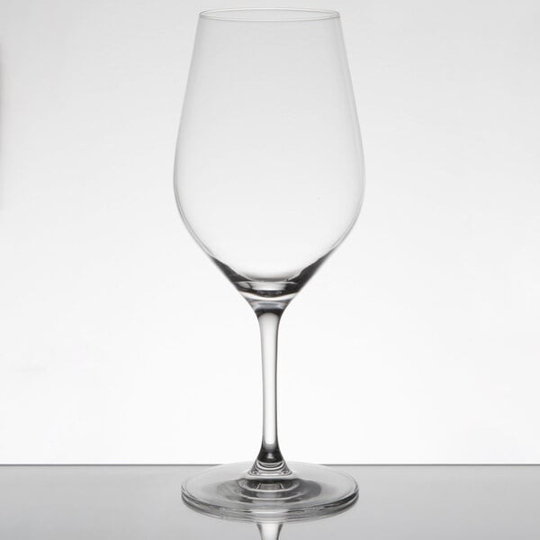A clear Chef & Sommelier Bordeaux wine glass on a table with a white background.