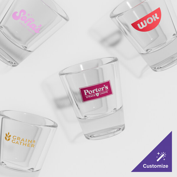 A group of GET plastic shot glasses with a pink logo.
