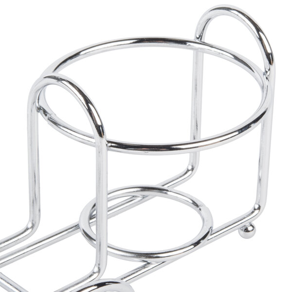 A silver metal Clipper Mill condiment caddy stand with a round menu holder.