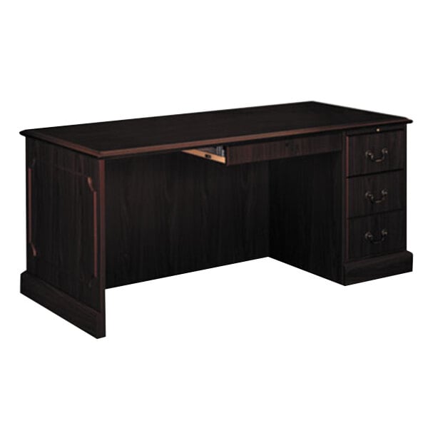 A dark wood desk with a drawer.