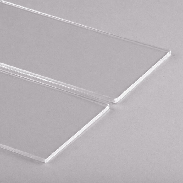 A close-up of a Clipper Mill clear plastic basket divider.
