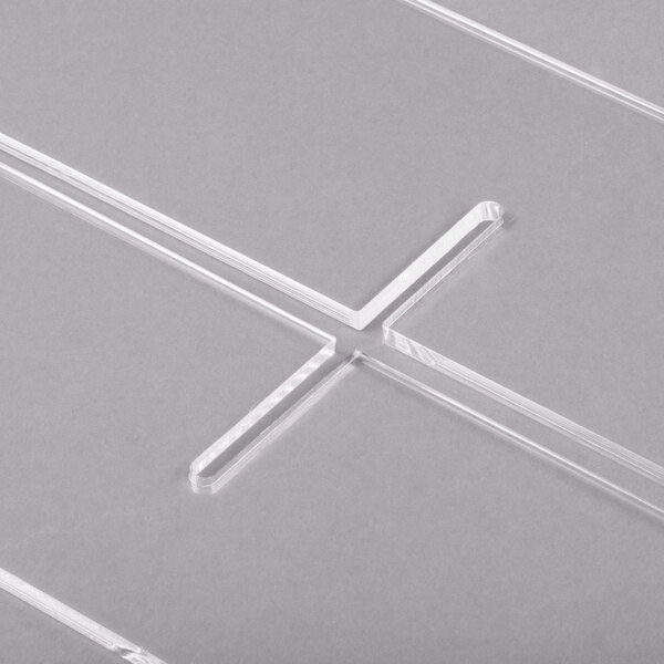 A clear plastic Clipper Mill by GET basket divider with four compartments in a cross shape.