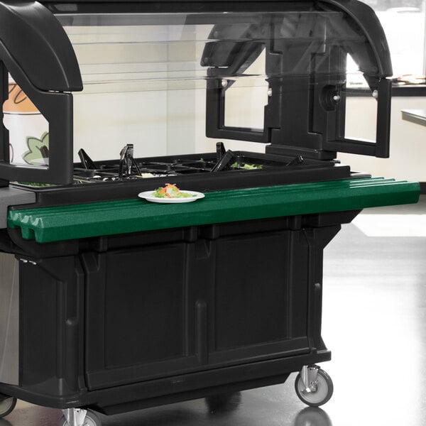 A green Cambro tray rail on a green and black Versa food cart.