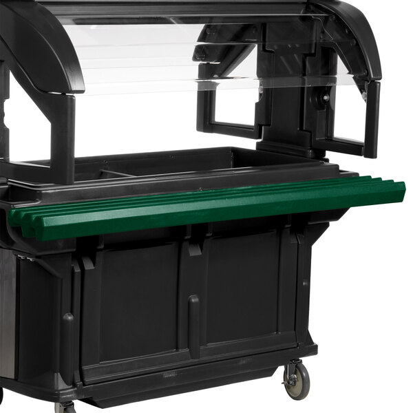 A green tray rail on a black food cart.