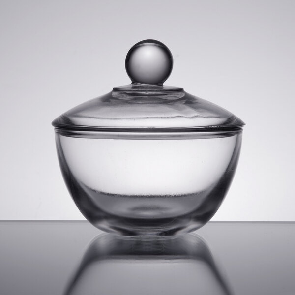 An Anchor Hocking clear glass bowl with a lid.