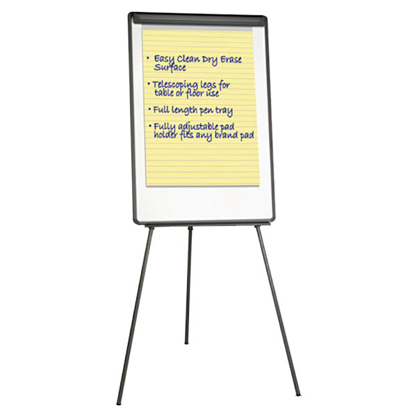 A Universal tripod style white board on a metal stand with a yellow notepad on it.