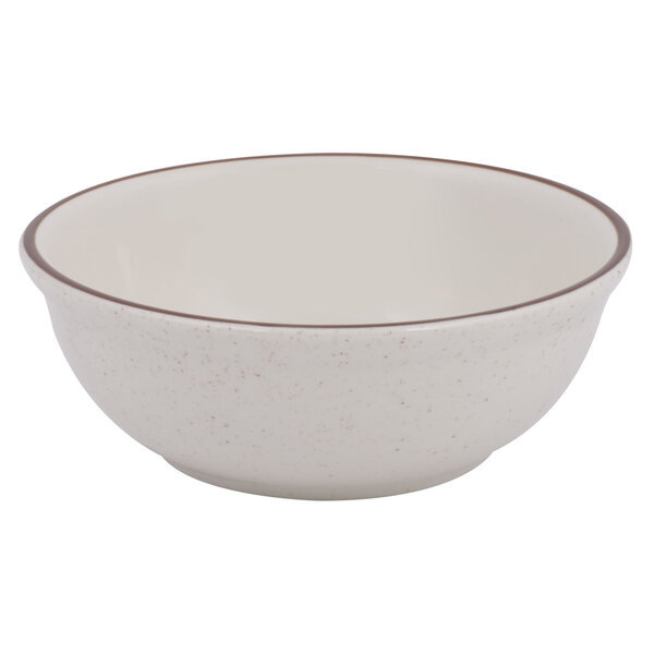 A white bowl with a brown speckled rim.