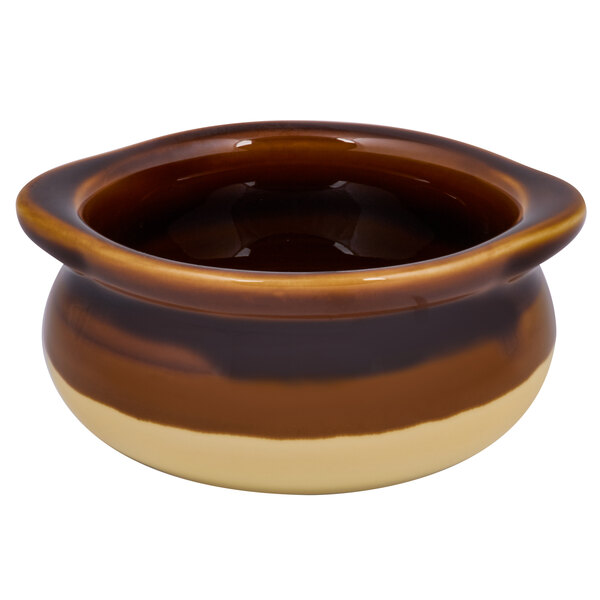A brown and white Tuxton China onion soup crock with a handle.