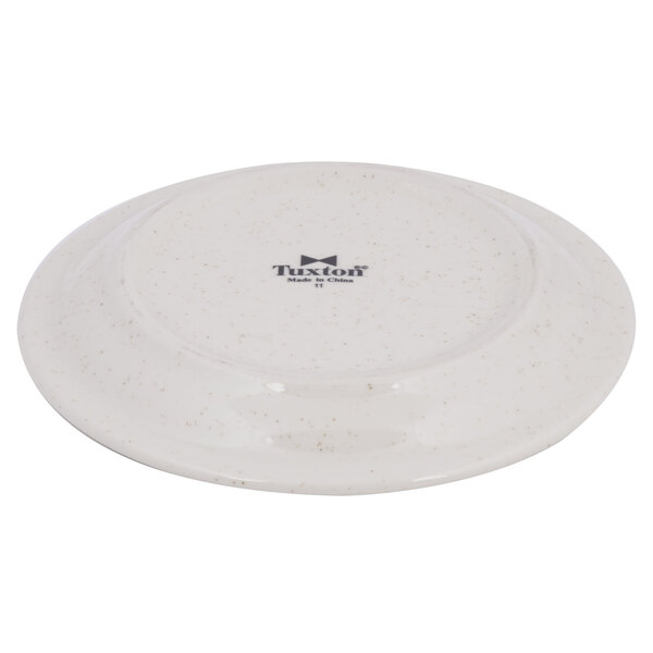 A white Tuxton narrow rim china plate with black speckles.