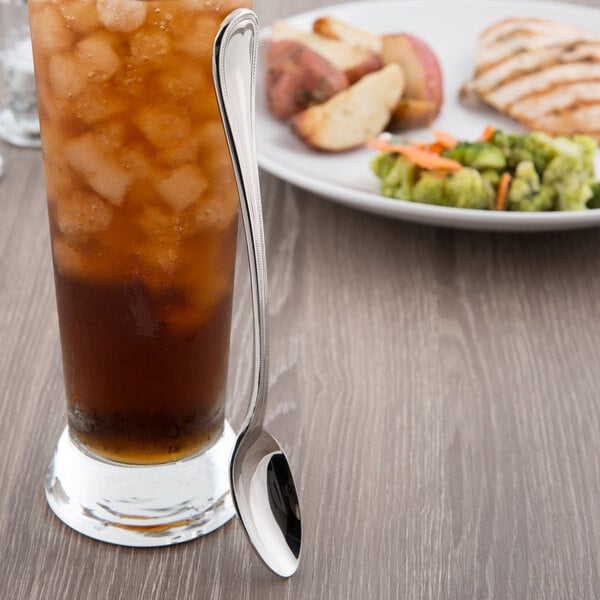 An iced tea glass with a Reed & Barton Chestnut Hill stainless steel spoon in it.
