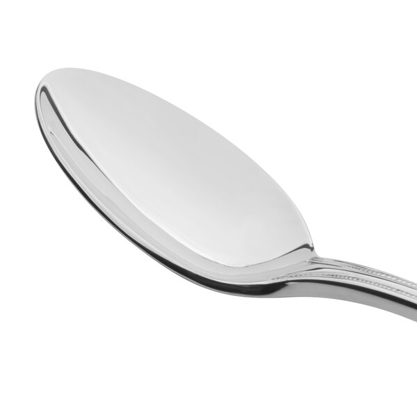 A close-up of a Reed & Barton stainless steel spoon with a silver handle.