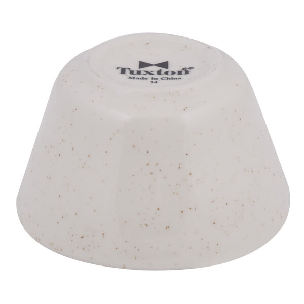 A white bowl with brown speckles.