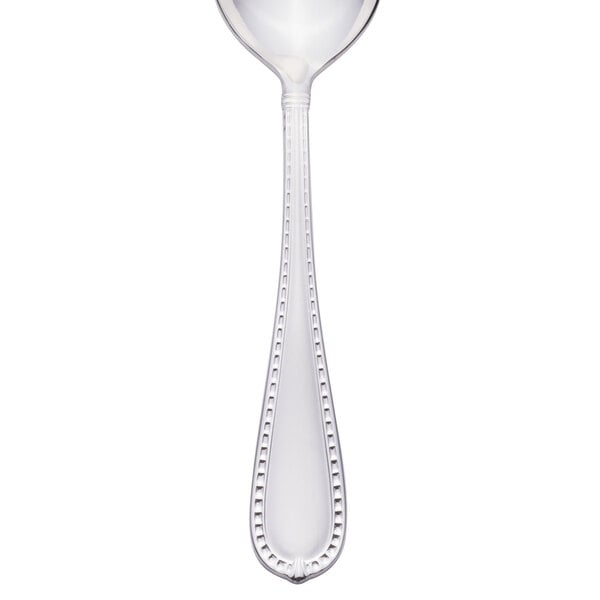 A silver dessert spoon with a beaded design on the handle.