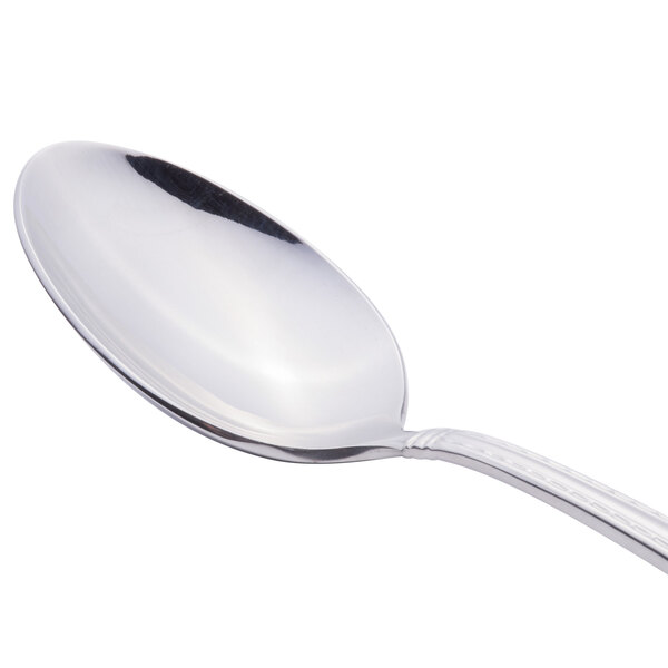 A close-up of a Reed & Barton stainless steel dessert spoon with a silver handle.