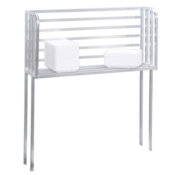 A Channel aluminum boat rack with a metal shelf holding two white square boxes.