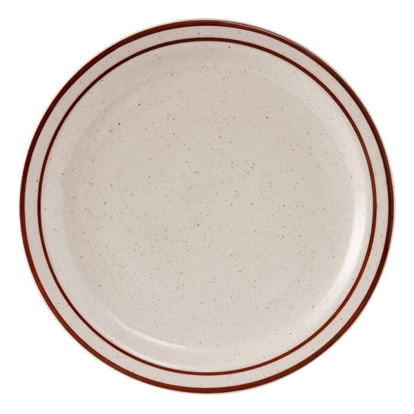 A white plate with a brown speckled surface and a red rim.