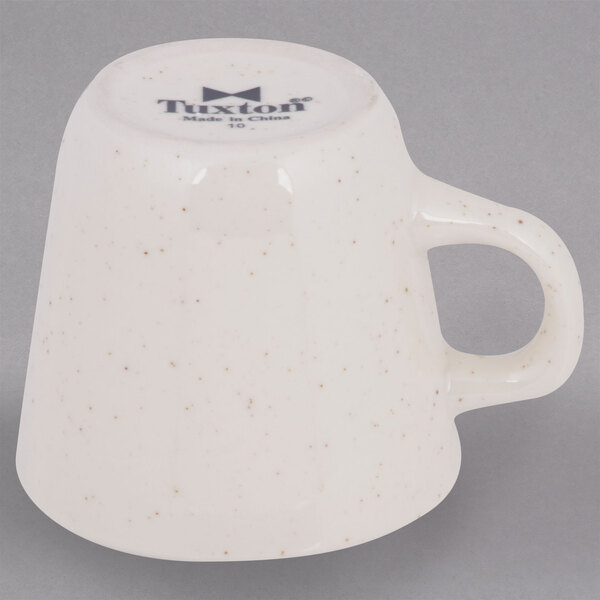 A Tuxton brown speckle tall china cup with a handle.