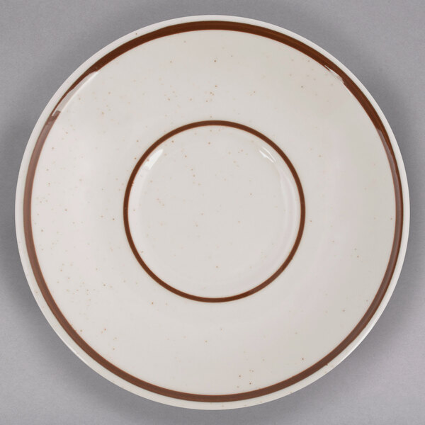 A Tuxton Bahamas brown speckle saucer with a brown rim.